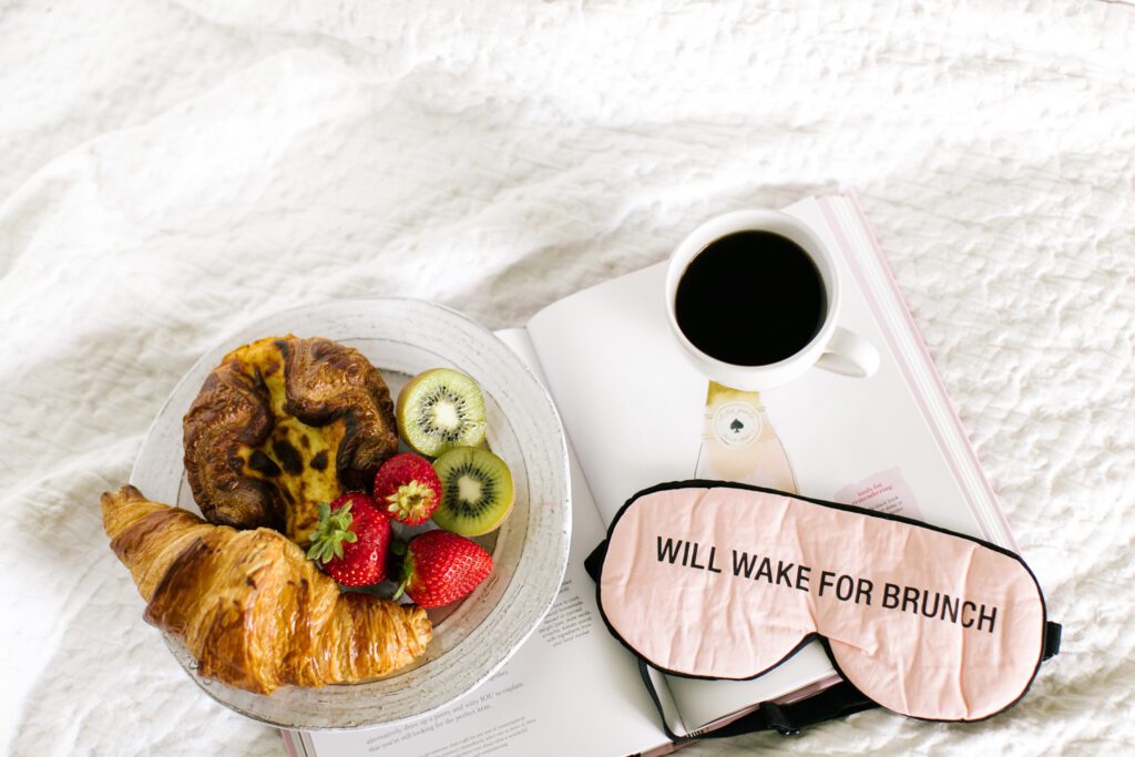 flat lay photo of fruit and bread with coffee and face mask: will wake for brunch